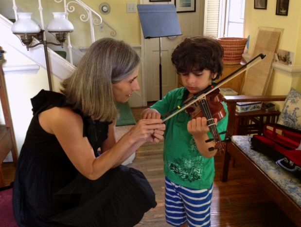 Violin student Tristan takes in the lovely techniques shown him by his Suzuki method teacher Constance during his violin lessons at her Beverly Hills violin studio.